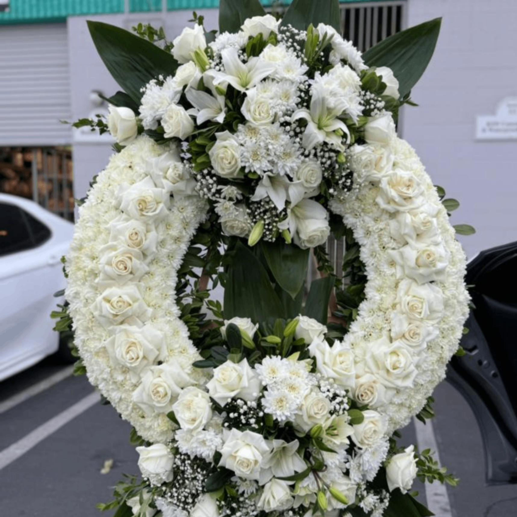 White funeral wreath standing spray