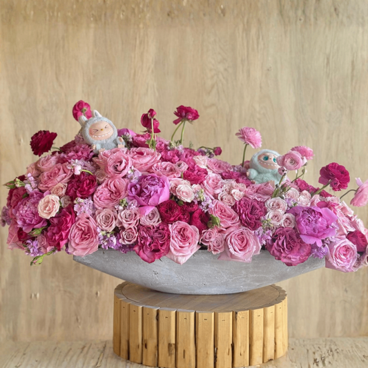 Pink rose centerpiece with figurines