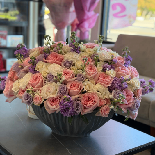 Pink lavender white roses gray vase