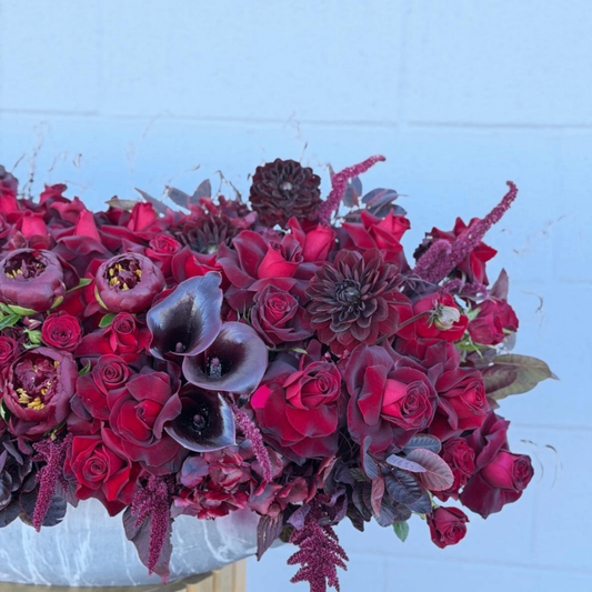 Burgundy roses dahlias calla lilies arrangement